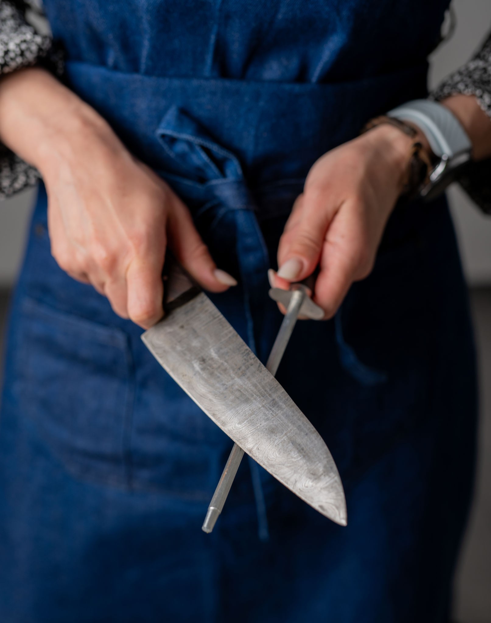 Large Kitchen Knife And Sharpener In Woman'S Hands